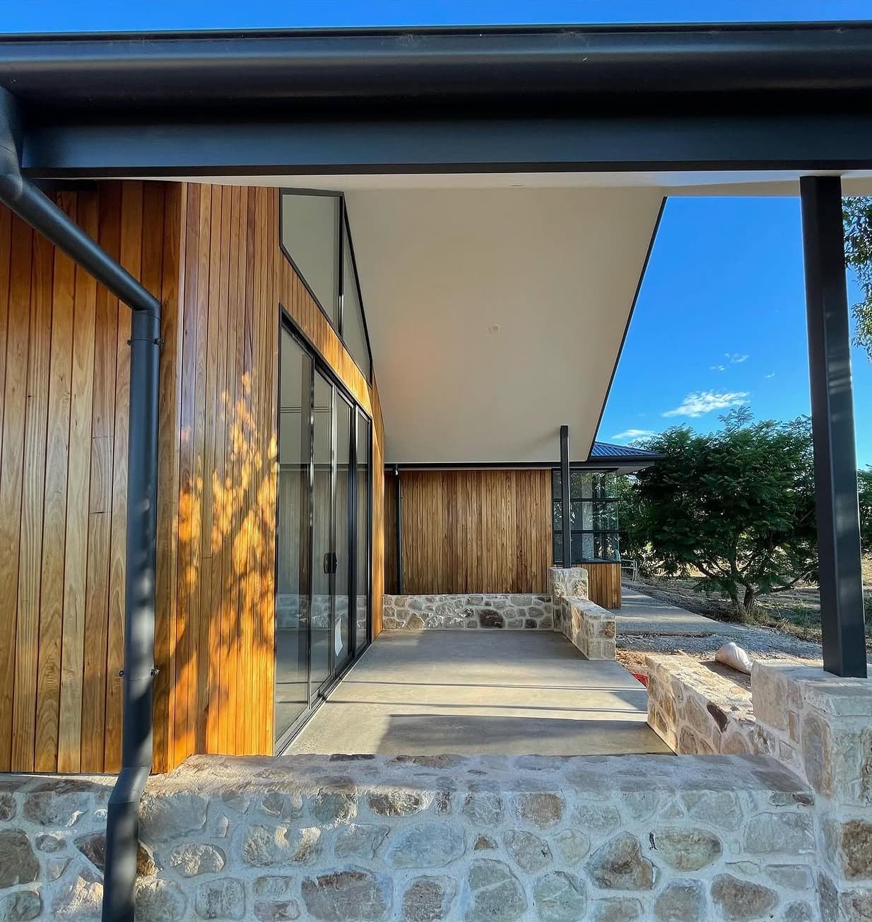 New home painters South Australia – custom-built home with oiled timber cladding and stone walls