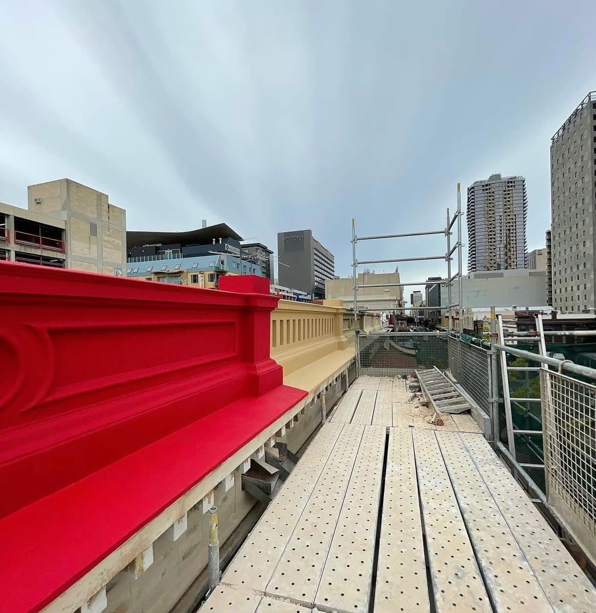 Strata and body corporate painters Adelaide CBD – multi-storey building facade repainted in red and cream