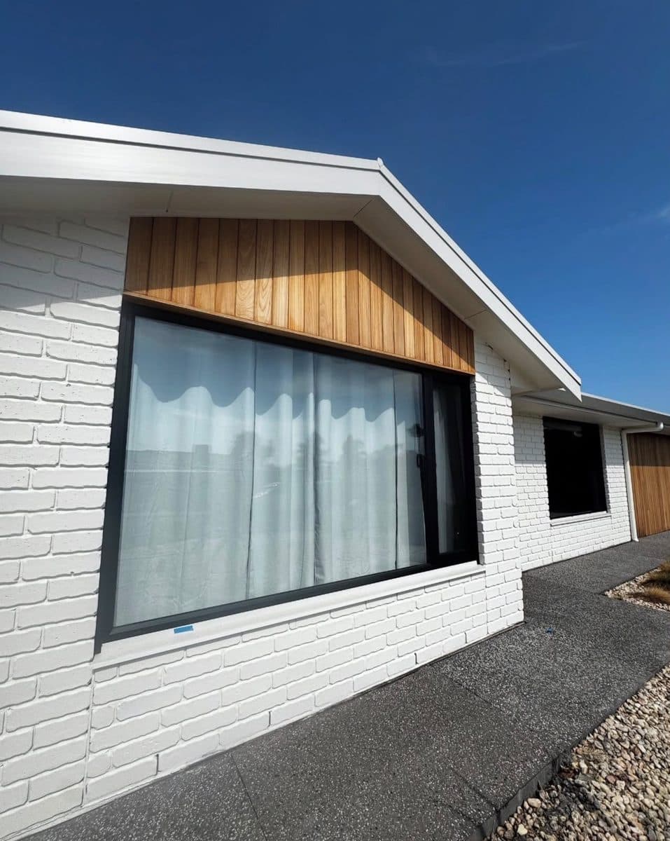 Brick house painting Marion – white painted brick exterior with timber gable and black window frames