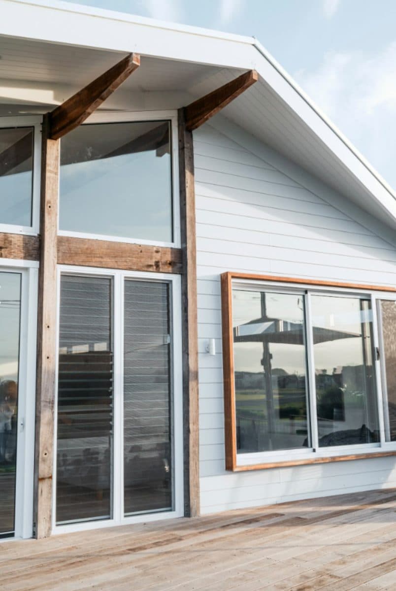 Weatherboard house painting Noarlunga – white exterior with timber posts and window trim