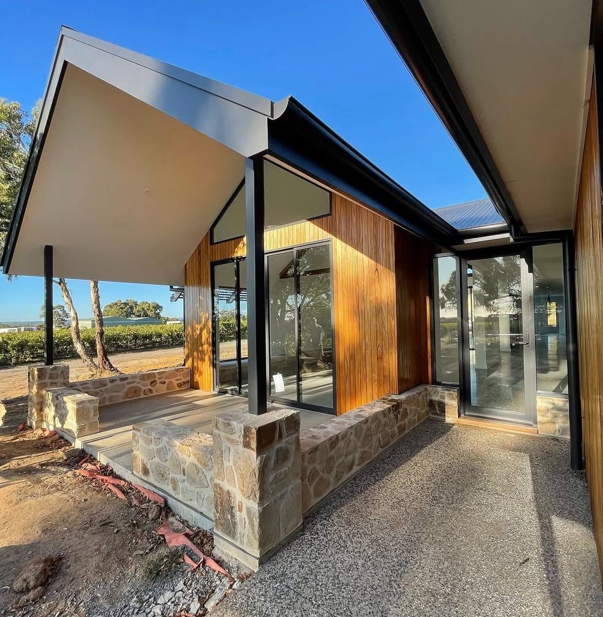 New home painters South Australia – architectural build with timber cladding, stone walls and charcoal steel